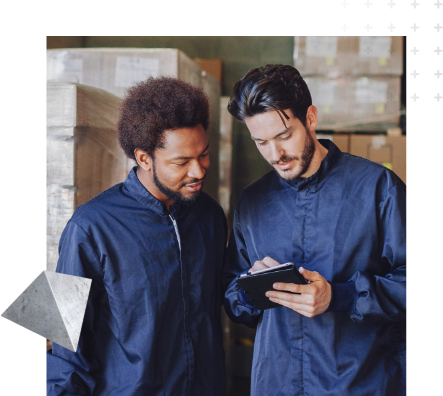 Two factory workers looking at tablet